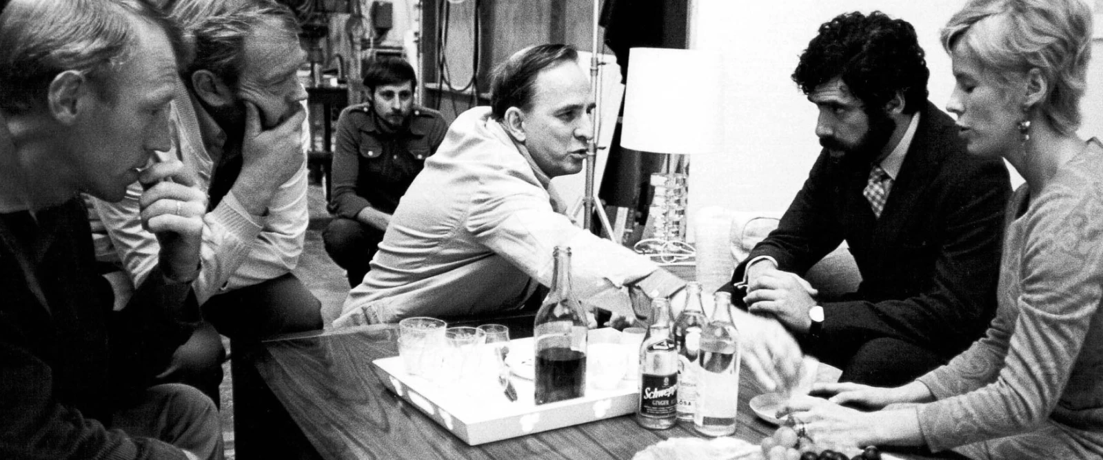 black and white photo of Ingmar Bergman and friends discussing a movie with max von sydow