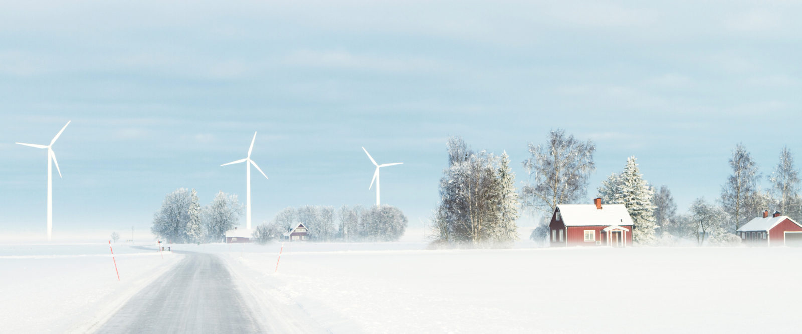 snow swept landscape with windmills and small houses